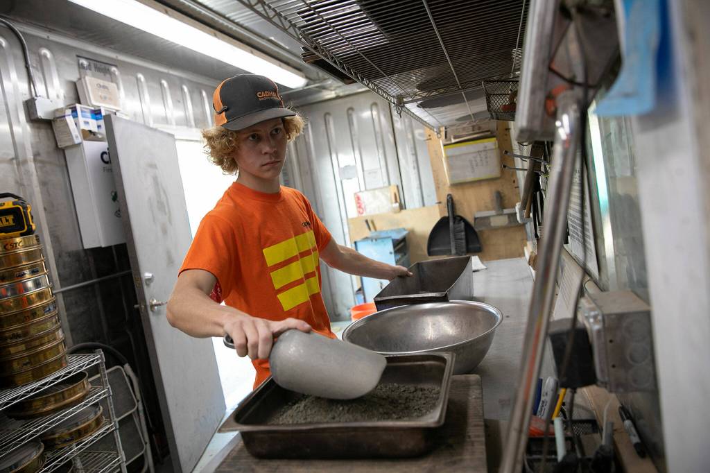 Quality Control Technician Grant Loen runs samples through tests in a lab at the Cadman, Inc. sand and gravel mine on Monday, in Granite Falls. (Ryan Berry / The Herald)
