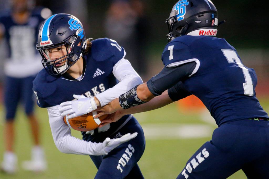Sultans Derek Feltner takes a handoff from quarterback Westin Galle against Granite Falls on Friday, Sep. 30, 2022, at Sultan High School in Sultan, Washington. (Ryan Berry / The Herald)