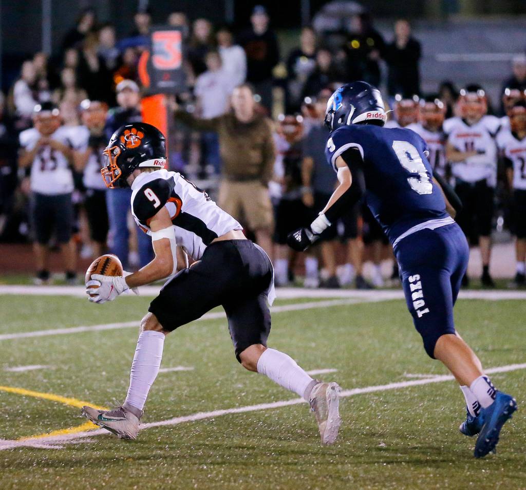 Granite Falls Johnathon Roberts Jr. picks off a ball tipped into the air and begins to take it the other way against Sultan on Friday, Sep. 30, 2022, at Sultan High School in Sultan, Washington. (Ryan Berry / The Herald)
