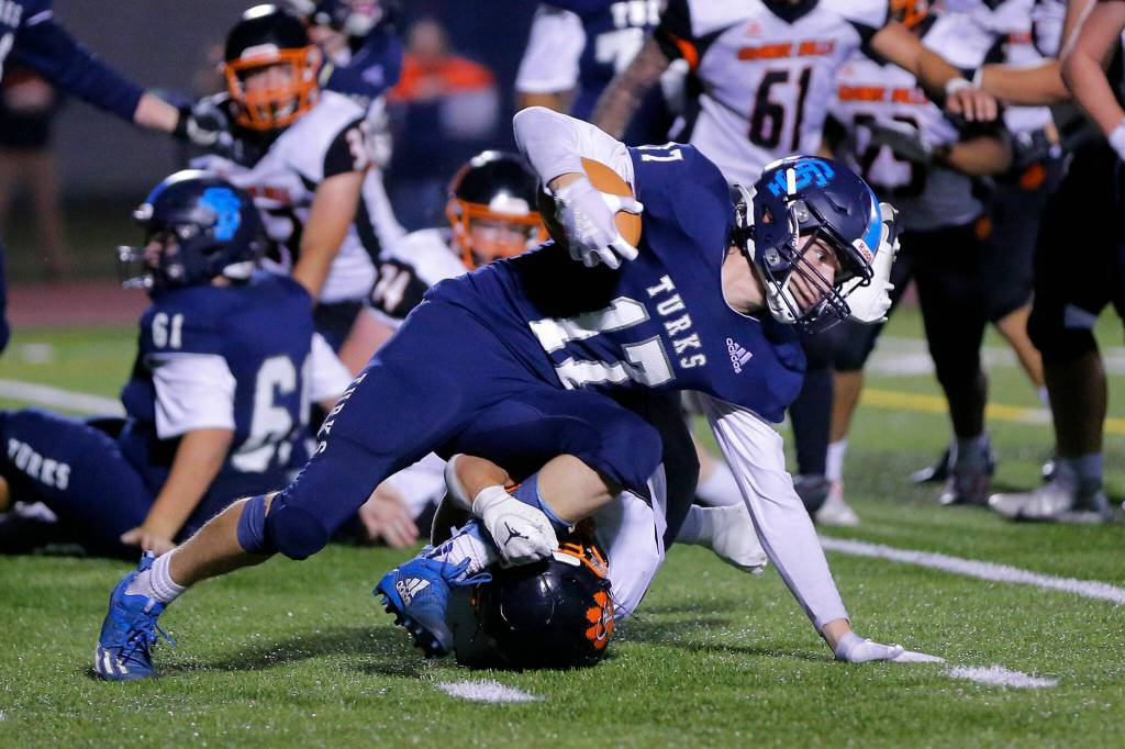 Sultans Derek Feltner tries to stay upright after picking up an offensive fumble and getting a few yards against Granite Falls on Friday, Sep. 30, 2022, at Sultan High School in Sultan, Washington. (Ryan Berry / The Herald)