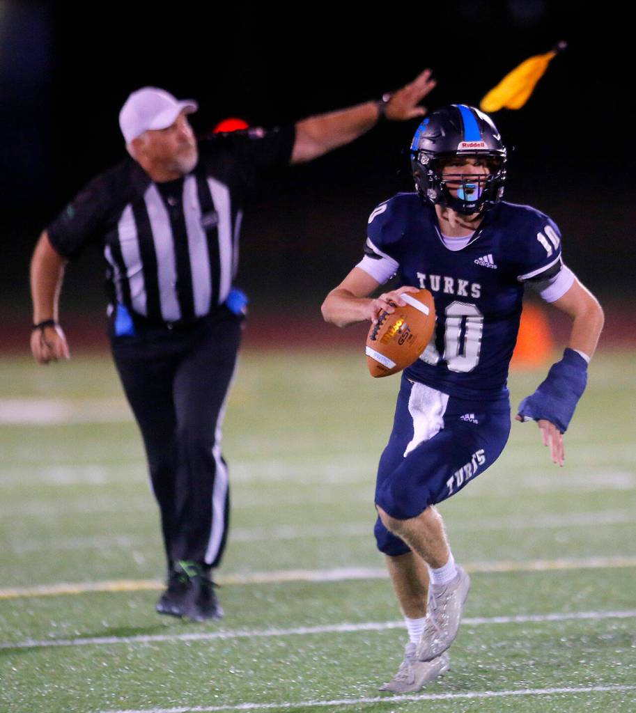 Sultans Kaden Koehler scrambles as an official throws a flag for offensive holding during Sultans matchup with Granite Falls on Friday, Sep. 30, 2022, at Sultan High School in Sultan, Washington. (Ryan Berry / The Herald)