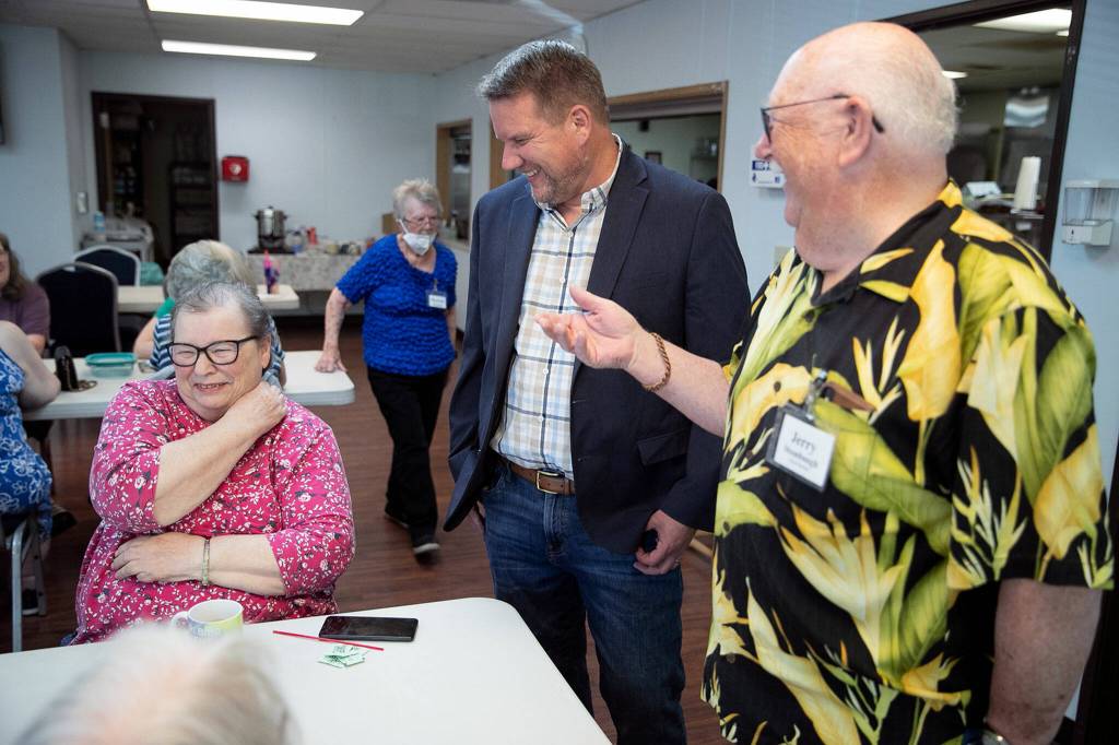 Sharon Lane, left, shares a laugh with Sam Low, center, Jerry Stumbaugh on July 20, Lake Stevens. (Kevin Clark / The Herald)
