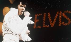 FILE - This 1972 file photo shows Elvis Presley during a performance. The AP reported on July 14, 2017, that a story claiming a dead homeless man in San Diego was identified as Presley is a hoax. Presley died in 1977. (AP Photo, File)