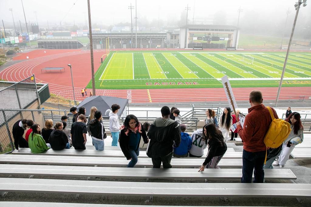 Jackson High students stick with their classmates and grab a seat in the bleachers during an Everett Public Schools emergency drill on Thursday, at Everett Memorial Stadium in Everett. (Ryan Berry / The Herald)