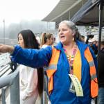Michelle Ulke shows students where to go after being united with their pretend guardians during an Everett Public Schools emergency drill on Thursday, at Everett Memorial Stadium in Everett. (Ryan Berry / The Herald)