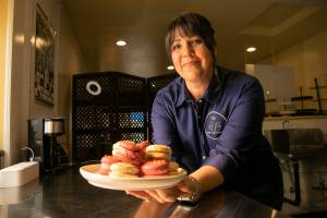 Lisa Laidlaw, owner and baker at House Balthazar, holds a plate of macarons in the kitchen Monday, Oct. 17, 2022, at House Balthazar in Monroe, Washington. (Ryan Berry / The Herald)