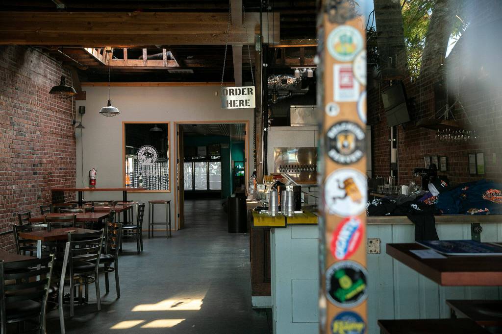 The interior of Toggles Bottle Shop is empty of staff and customers on Monday, in downtown Everett. (Ryan Berry / The Herald)