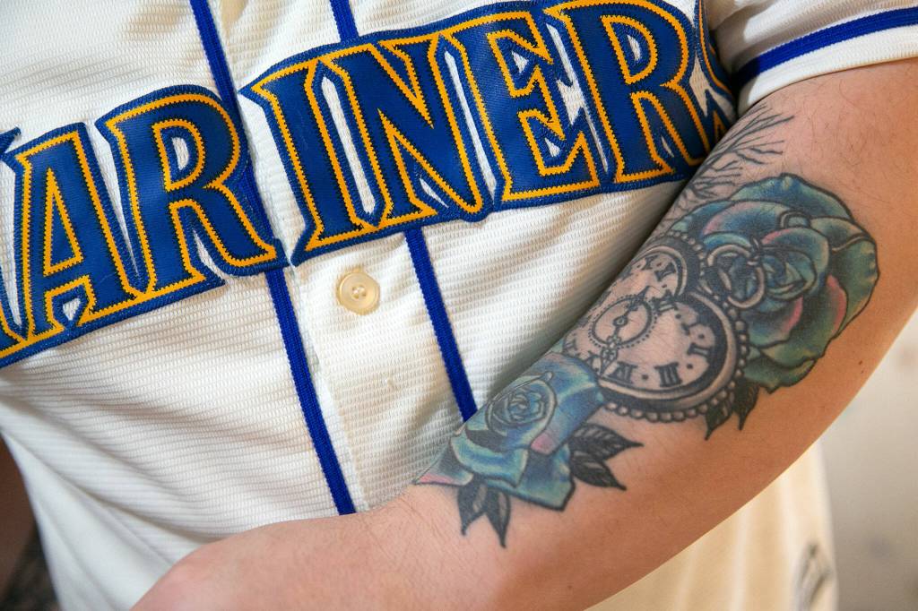 James Muramotos arm is tattooed in memory of his late grandmother Edie Galen, who taught him to love Mariners baseball, on Thursday, in Everett. (Ryan Berry / The Herald)