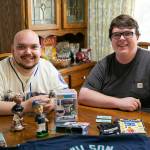 Mariners fans James Muramoto, 29 and brother Matt Kopp, 23, sit at the dining room table at their family’s home on Thursday, Oct. 5, 2022, in Everett, Washington. Muramoto said he has been a lifelong Mariners fan thanks to the passion of his late grandmother Edie Galen. (Ryan Berry / The Herald)
