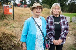 Phyllis Hopkins, left, and Debbie Wetzel at the site of the Cathcart Crossing project on Thursday, Sept. 22, 2022 in Cathcart, Washington. Hopkins is one of 13 neighbors who was left out of the loop about a public hearing and comment period for the proposed development, an appeal alleges. (Olivia Vanni / The Herald)
