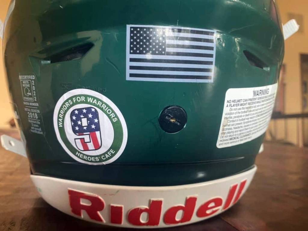 Edmonds-Woodway players are wearing a decal on the back of their helmets this season to show support for Moses Martins fundraising efforts for Heroes Cafe. (Earl Martin)