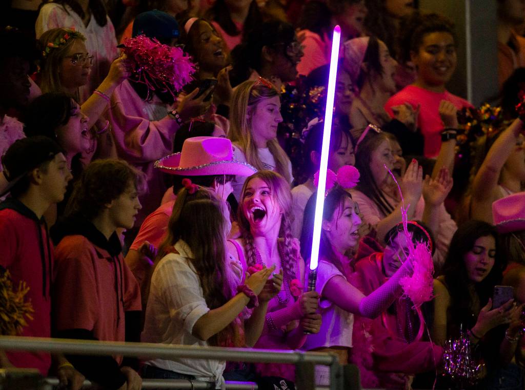 A Lake Stevens fan reacts to getting the purple lightsaber during the game against Eastlake on Friday, Oct. 7, 2022 in Lake Stevens, Washington. (Olivia Vanni / The Herald)