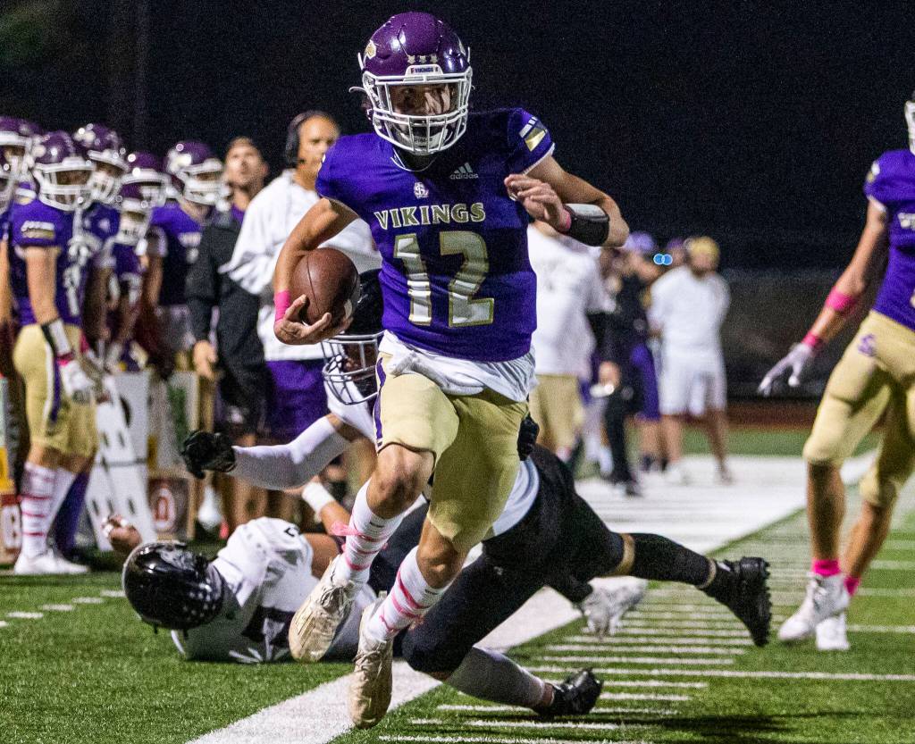 Lake Stevens Kolton Mason runs the ball down the sideline during the game against Eastlake on Friday, Oct. 7, 2022 in Lake Stevens, Washington. (Olivia Vanni / The Herald)