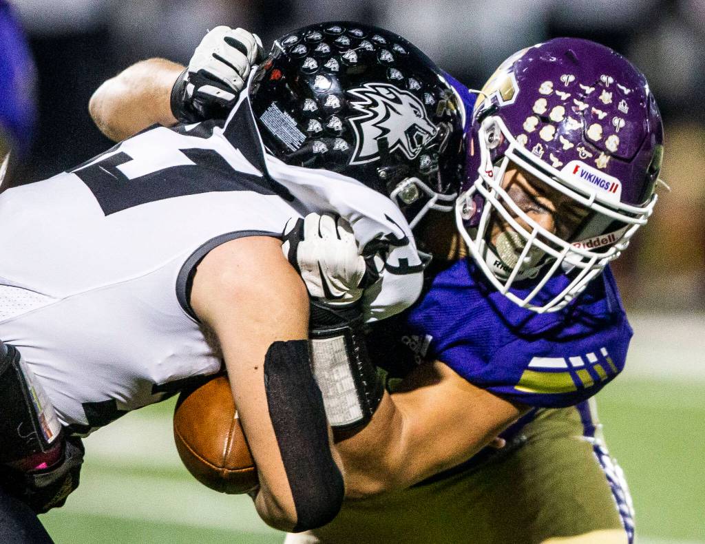 Lake Stevens Micah Avery tackles Eastlakes Blake Born during the game on Friday, Oct. 7, 2022 in Lake Stevens, Washington. (Olivia Vanni / The Herald)