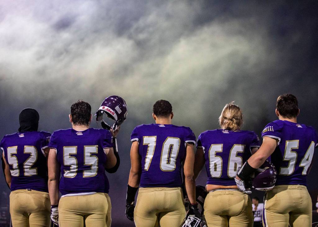 Lake Stevens players line up for the National Anthem before the start of the game against Eastlake on Friday, Oct. 7, 2022 in Lake Stevens, Washington. (Olivia Vanni / The Herald)