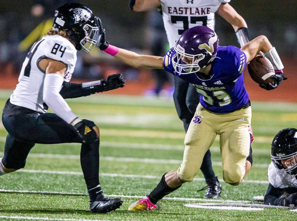 Lake Stevens receiver David Brown stiff-arms an Eastlake defender. (Olivia Vanni / The Herald)