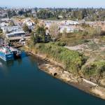 An unknown derelict barge grounded along the bank of the Snohomish River off of Railway Avenue on Tuesday, in Everett. (Olivia Vanni / The Herald)
