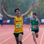 Shorecrest senior George Fernandez celebrates as he crosses the line to win the boys silver race. (Olivia Vanni / The Herald)