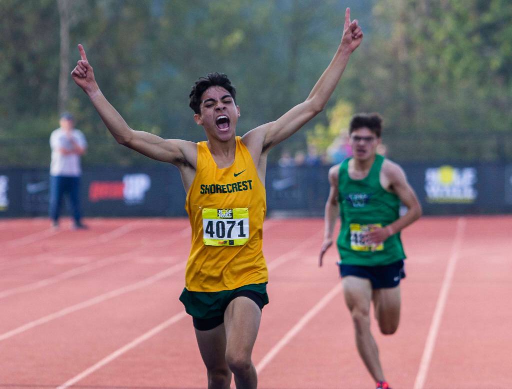 Shorecrest senior George Fernandez celebrates as he crosses the line to win the boys silver race. (Olivia Vanni / The Herald)