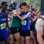 Runners hug after finishing their race at the Hole In The Wall Invitational on Saturday, Oct. 8, 2022 in Arlington, Washington. (Olivia Vanni / The Herald)