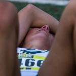A runner bites down on their necklace and cries after finishing their race at the Hole In The Wall Invitational on Saturday, Oct. 8, 2022 in Arlington, Washington. (Olivia Vanni / The Herald)