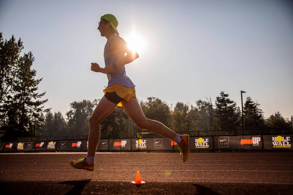 A boys elite runner makes their way toward the finish line at the Hole In The Wall Invitational on Saturday, Oct. 8, 2022 in Arlington, Washington. (Olivia Vanni / The Herald)
