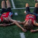 A Snohomish and Kings runner lay on the ground after their race at the Hole In The Wall Invitational on Saturday, Oct. 8, 2022 in Arlington, Washington. (Olivia Vanni / The Herald)