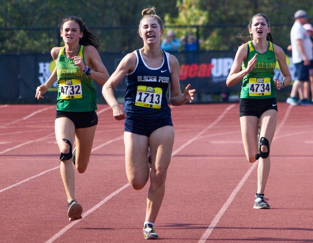 Glacier Peaks Clara Diepenbrock grimaces as she runs toward the finish line at the Hole In The Wall Invitational on Saturday, Oct. 8, 2022 in Arlington, Washington. (Olivia Vanni / The Herald)