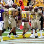 Arizona State running back Xazavian Valladay (1) celebrates after his touchdown run with wide receiver Giovanni Sanders (20), offensive lineman Ben Scott (66), tight end Messiah Swinson (80) and offensive lineman Emmit Bohle (70) as Washington linebacker Kamren Fabiculanan (13) walks back to the sideline during the first half of a game Saturday in Tempe, Ariz. (AP Photo/Ross D. Franklin)