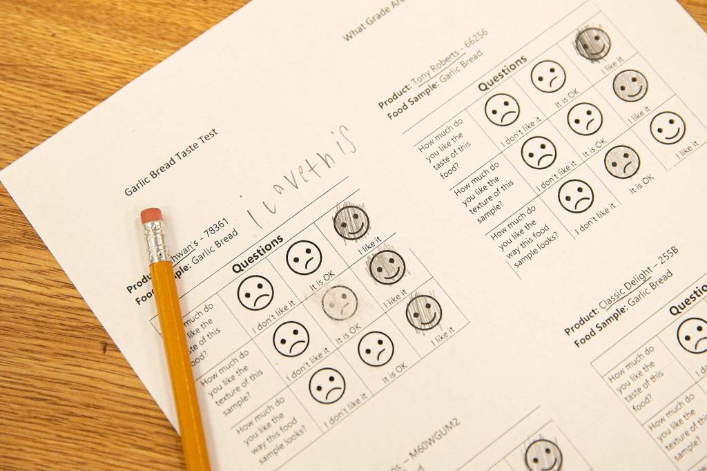 A review sheet is filled out after a group of third graders sampled four types of garlic bread Tuesday, at Eagle Creek Elementary, in Arlington. (Ryan Berry / The Herald)