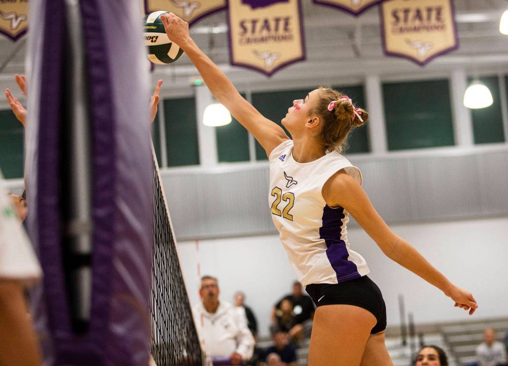 Lake Stevens Laura Eichert tips the ball over the top of the net during the match against Glacier Peak on Tuesday, Oct. 11, 2022 in Lake Stevens, Washington. (Olivia Vanni / The Herald)