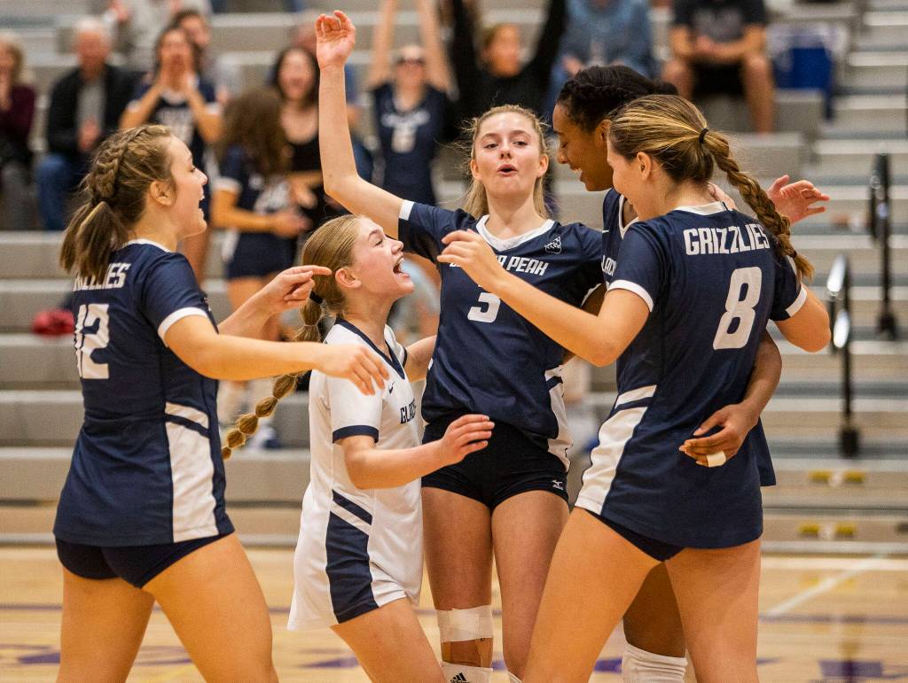 Glacier Peak players celebrate a point during the match against Lake Stevens on Tuesday, Oct. 11, 2022 in Lake Stevens, Washington. (Olivia Vanni / The Herald)