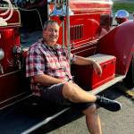 James Sullivan sitting on the 1934 Seagrave fire engine he restored. (Photo courtesy of James Sullivan)