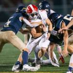 Stanwoods Ryan Bumgarner runs through a tackle during the Stilly Cup against Arlington on Sept. 30 at Arlington High School. Bumgarner leads the area in rushing yards this season. (Olivia Vanni / The Herald)