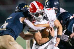 Stanwood’s Ryan Bumgarner runs through a tackle during the Stilly Cup against Arlington on Friday, Sept. 30, 2022 in Arlington, Washington. (Olivia Vanni / The Herald)