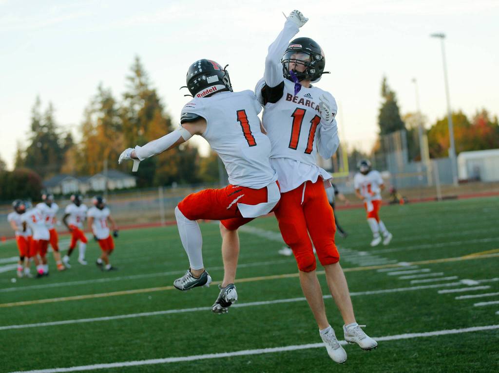 Monroes Mason Davis (1) celebrates with Trent Bublitz (11) after Bublitzs touchdown reception against Edmonds-Woodway on Friday, Oct. 14, 2022, at Edmonds School District Stadium in Edmonds, Washington. (Ryan Berry / The Herald)
