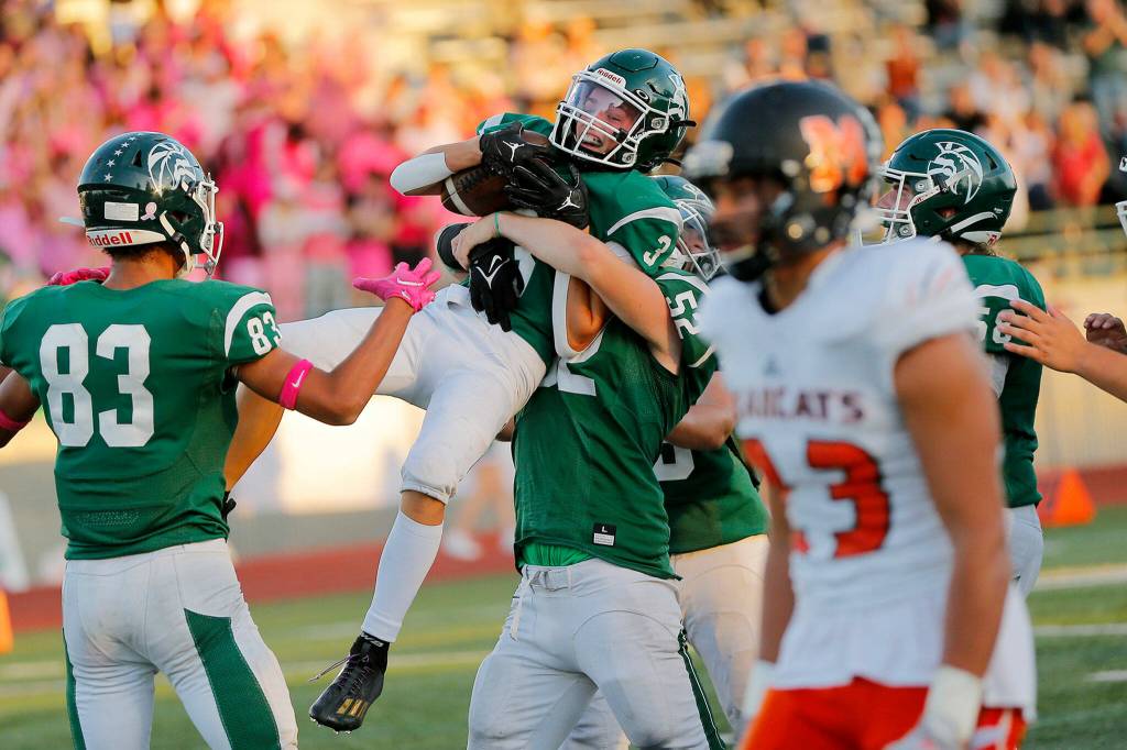 Edmonds-Woodways Cannon Kennard gets hoisted into the air after a circus catch for a touchdown in the back of the end zone against Monroe on Friday, Oct. 14, 2022, at Edmonds School District Stadium in Edmonds, Washington. (Ryan Berry / The Herald)