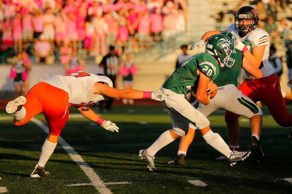 Edmonds-Woodways Liam Fitting slips the first tackle while trying to find space on a run against Monroe on Friday, Oct. 14, 2022, at Edmonds School District Stadium in Edmonds, Washington. (Ryan Berry / The Herald)