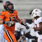 Oregon State's Jack Colletto celebrates in front of Washington State defensive back Jordan Lee after his touchdown during the first half of an NCAA college football game Saturday, Oct. 15, 2022, in Corvallis, Ore. (AP Photo/Mark Ylen)