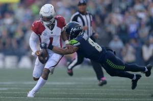 Arizona Cardinals quarterback Kyler Murray (1) fumbles while tackled by Seattle Seahawks cornerback Coby Bryant, right, during the second half Sunday at Lumen Field. (AP Photo/Caean Couto)