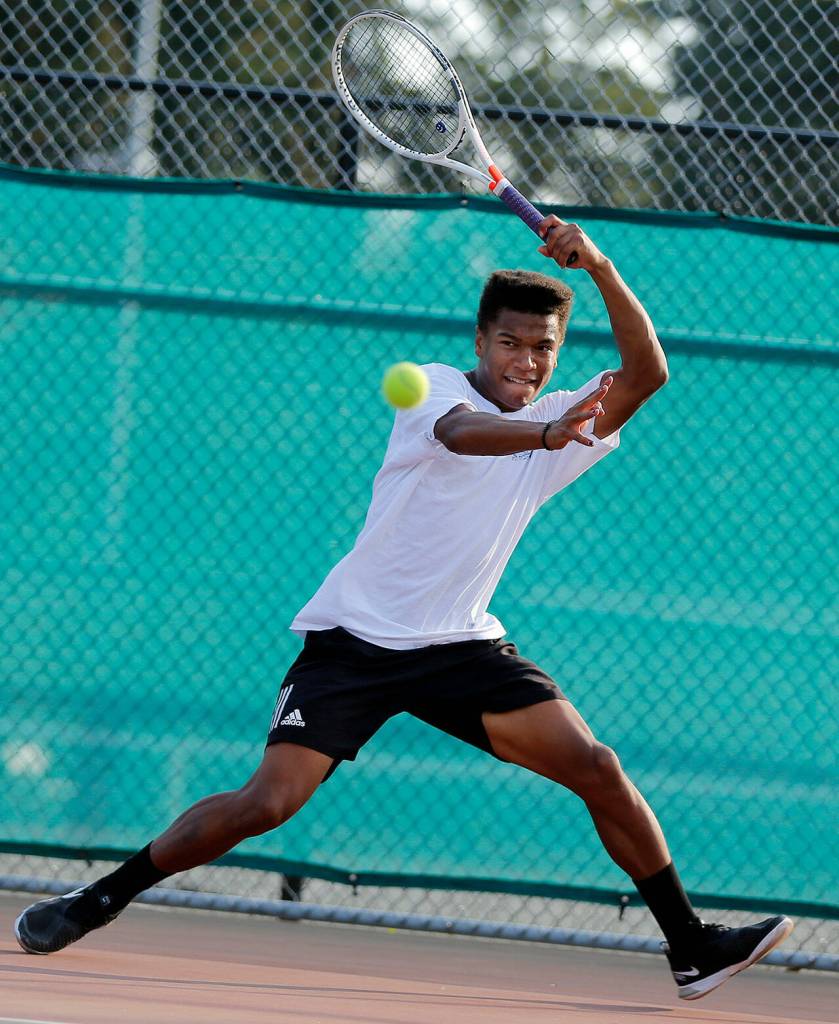 Russell Anderson returns a ball over the net during a team practice Monday, Oct. 17, 2022, at Edmonds-Woodway High School in Edmonds, Washington. (Ryan Berry / The Herald)