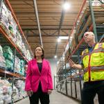 U.S. Rep. Suzan DelBene is shown around the food storage warehouse by VOA Director of Operations for Hunger Prevention Dean Johnson on Thursday, at the Volunteers of America food distribution center in Arlington. (Ryan Berry / The Herald)