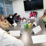 Officials from multiple organizations dealing with the baby formula shortage gather for a discussion Thursday, at the Volunteers of America food distribution center in Arlington. (Ryan Berry / The Herald)