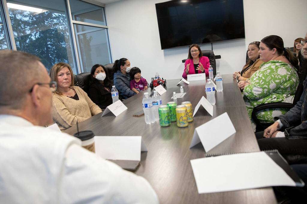 Officials from multiple organizations dealing with the baby formula shortage gather for a discussion Thursday, at the Volunteers of America food distribution center in Arlington. (Ryan Berry / The Herald)
