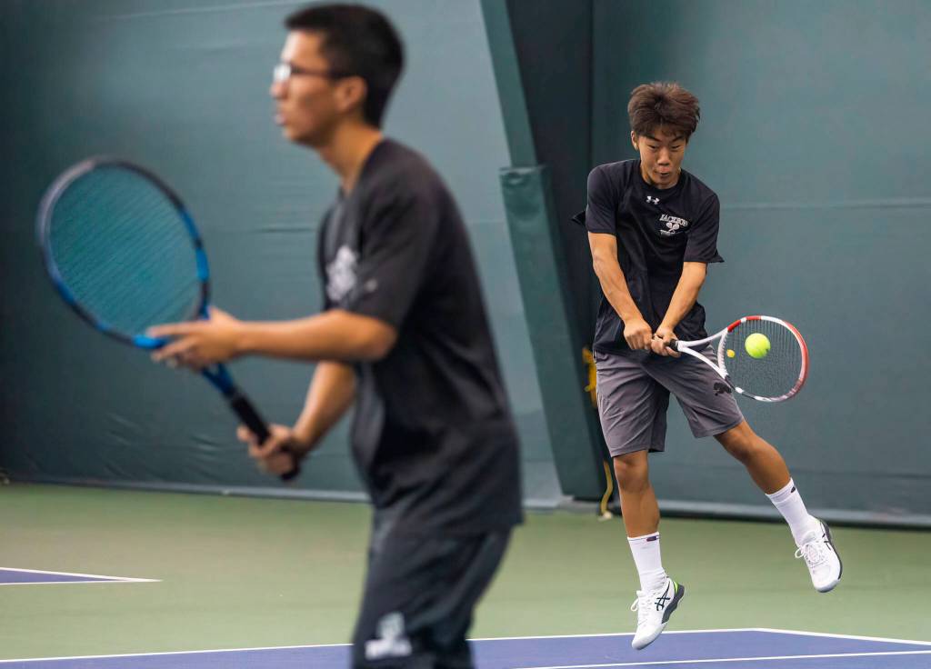 Jackson freshman David Song (right) and junior Henry Park rolled to the district doubles title. (Olivia Vanni / The Herald)