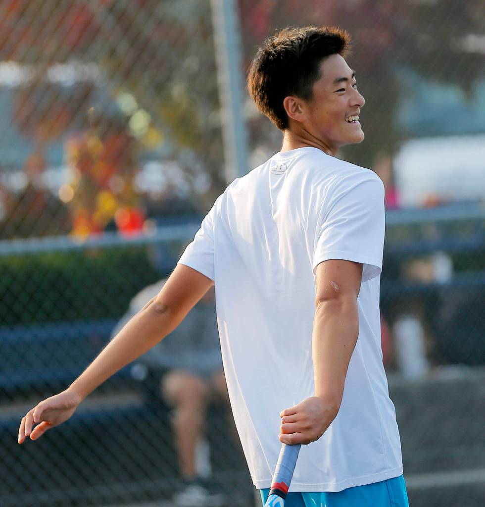 Jackson High sophomore Ben Lee cracks a smile while playing against senior teammate Austen Lim during the 4A District 1 Singles Championship Tuesday, Oct. 18, 2022, at Glacier Peak High School in Snohomish, Washington. (Ryan Berry / The Herald)