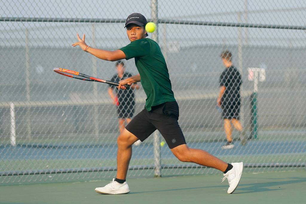 Jackson High senior Austen Lim returns a ball against sophomore teammate Ben Lee during the 4A District 1 Singles Championship Tuesday, Oct. 18, 2022, at Glacier Peak High School in Snohomish, Washington. (Ryan Berry / The Herald)