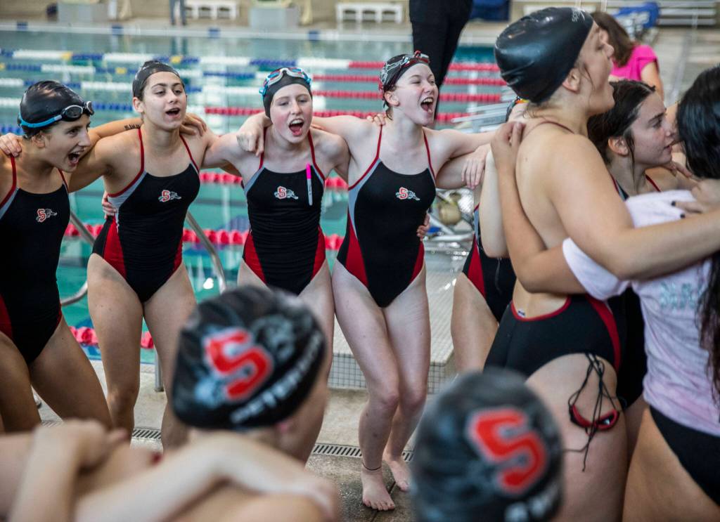 The Snohomish swim team chants before the start of their meet against Glacier Peak on Tuesday, Oct. 18, 2022 in Snohomish, Washington. (Olivia Vanni / The Herald)