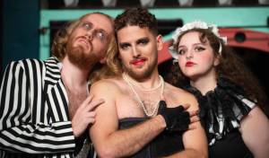 Frank_Riff_Magenta: Handyman Riff Raff (Kendall Collins), mad scientist Dr. Frank-N-Furter (Josiah Miller) and crazed domestic Magenta (Lauren Hayes) host unsuspecting guests in “The Rocky Horror Show,” playing October 21-November 6 at the Red Curtain Arts Center in Marysville. (Kenny Randall)