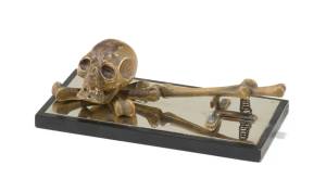 This paper clip features a bronze skull and bones, making it ready for Halloween any time of the year. Is it a modern-day memento mori or a sly comment on the tedium of paperwork?